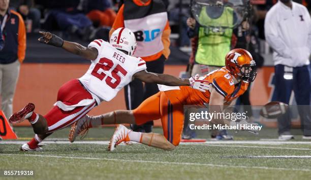 Bobby Walker of the Illinois Fighting Illini reaches to catch the pass as Antonio Reed of the Nebraska Cornhuskers defends at Memorial Stadium on...