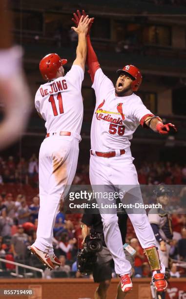 The St. Louis Cardinals' Jose Martinez, right, celebrates with Paul DeJong after he drove in DeJong with a two-run home run in the ninth inning...