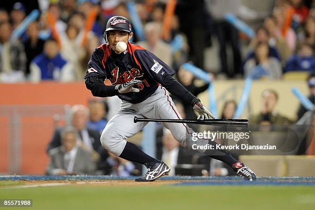 Ichiro Suzuki of Japan lays down a sacrafice bunt in the seventh inning of the finals of the 2009 World Baseball Classic against Korea on March 23,...