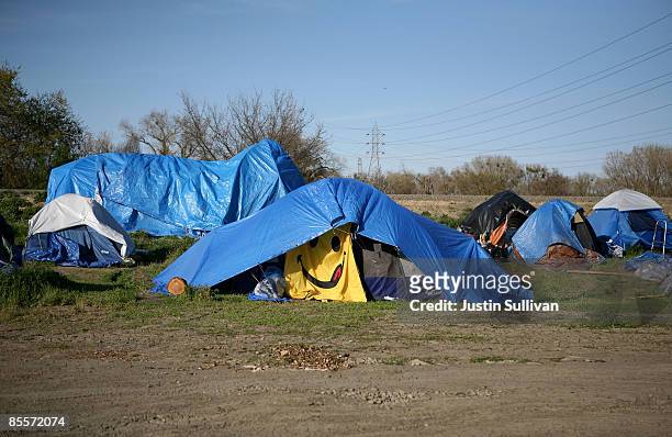 Happy face blanket hangs on the outside of a tent at a homeless tent city March 23, 2009 in Sacramento, California. Sacramento mayor Kevin Johnson...