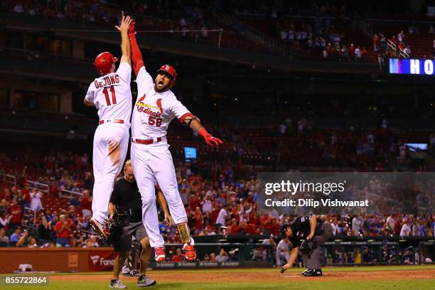 Jose Martinez of the St. Louis Cardinals celebrates with Paul DeJong after hitting a two-run home run against the Milwaukee Brewers in the ninth...