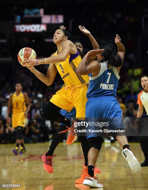 Candace Parker of the Los Angeles Sparks shoots in between Alexis Jones of the Minnesota Lynx and Jia Perkins of the Minnesota Lynx during the first...