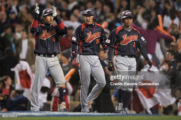 Akinori Iwamura and Seiichi Uchikawa celebrate after scoring with Hiroyuki Nakajima on Ichiro Suzuki single the tenth inning of the finals of the...