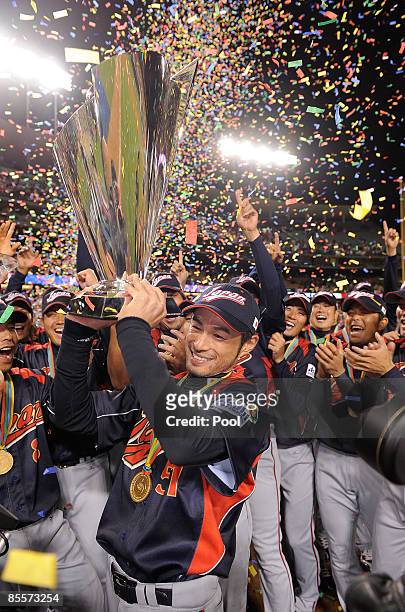 Ichiro Suzuki of Japan holds up the championship trophy after defeating Korea during the finals of the 2009 World Baseball Classic on March 23, 2009...