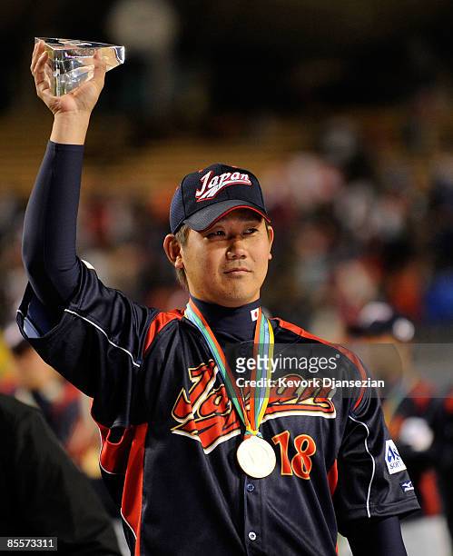Daisuke Matsuzaka of Japan holds up the the MVP trophy after defeating Korea during the finals of the 2009 World Baseball Classic on March 23, 2009...