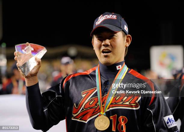 Daisuke Matsuzaka of Japan holds up the the MVP trophy after defeating Korea during the finals of the 2009 World Baseball Classic on March 23, 2009...
