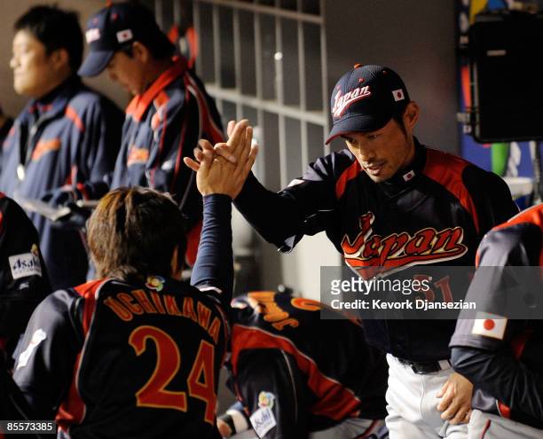 Seiichi Uchikawa and Ichiro Suzuki celebrate after scoring on Suzuki double in the tenth inning of the finals of the 2009 World Baseball Classic on...