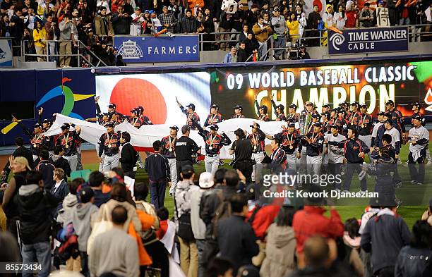 Japan players hold up their nation's flag after defeating Korea during the finals of the 2009 World Baseball Classic on March 23, 2009 at Dodger...
