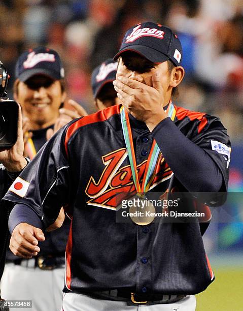 Daisuke Matsuzaka of Japan reacts to being named the MVP trophy after defeating Korea during the finals of the 2009 World Baseball Classic on March...