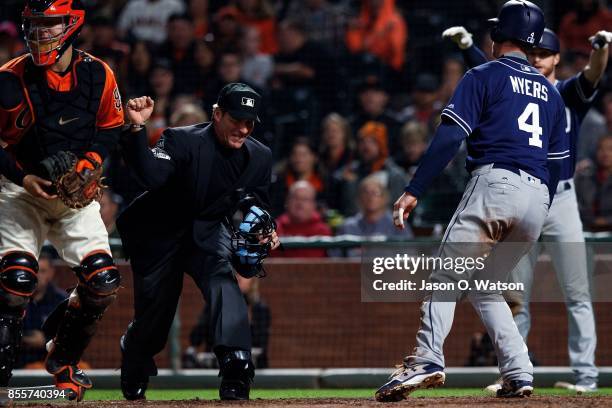 Umpire Angel Hernandez calls out Wil Myers of the San Diego Padres after he was tagged at home plate by Nick Hundley of the San Francisco Giants...