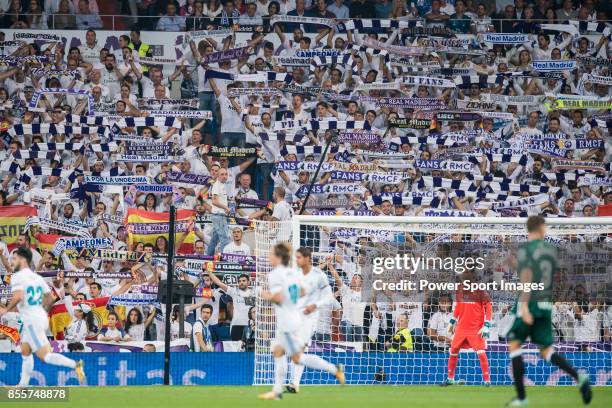 Fans of Real Madrid cheer during the La Liga 2017-18 match between Real Madrid and Real Betis at Estadio Santiago Bernabeu on 20 September 2017 in...