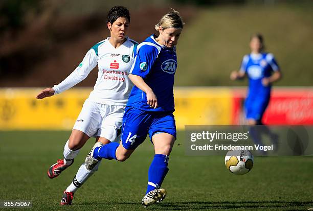 Jennifer Zietz of Potsdam is challenged by Linda Bresonik of Duisburg during the Women's Bundesliga match between FCR 2001 Duisburg and FFC Turbine...