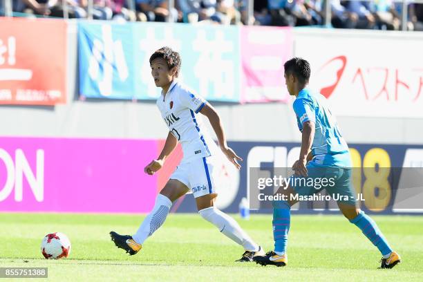 Kento Misao of Kashima Antlers and Yuji Ono of Sagan Tosu compete for the ball during the J.League J1 match between Sagan Tosu and Kashima Antlers at...