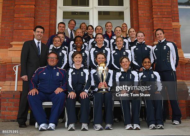 Charlotte Edwards, the England captain, holds the World Cup trophy with the rest of the England team and Andy Burnham , the of Secretary of State for...