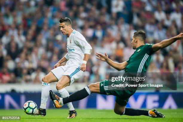 Cristiano Ronaldo of Real Madrid is tackled by Zouhair Feddal Agharbi of Real Betis during the La Liga 2017-18 match between Real Madrid and Real...