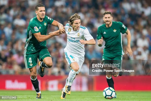 Luka Modric of Real Madrid fights for the ball with Zouhair Feddal Agharbi of Real Betis during the La Liga 2017-18 match between Real Madrid and...