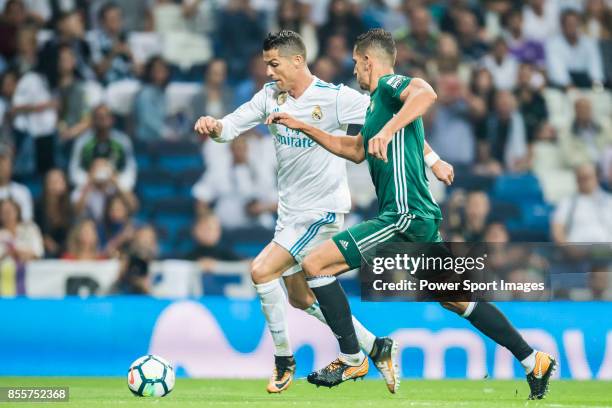 Cristiano Ronaldo of Real Madrid is tackled by Zouhair Feddal Agharbi of Real Betis during the La Liga 2017-18 match between Real Madrid and Real...