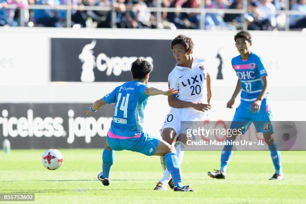 Kento Misao of Kashima Antlers and Yoshiki Takahashi of Sagan Tosu compete for the ball during the J.League J1 match between Sagan Tosu and Kashima...