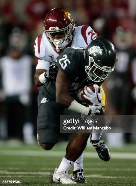 Jamal Morrow of the Washington State Cougars is tackled by Jack Jones of the USC Trojans in the second half at Martin Stadium on September 29, 2017...