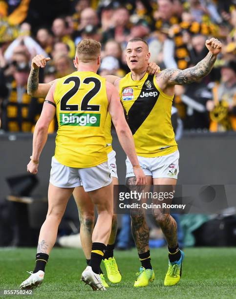 Josh Caddy, Brandon Ellis and Dustin Martin of the Tigers celebrate winning the 2017 AFL Grand Final match between the Adelaide Crows and the...