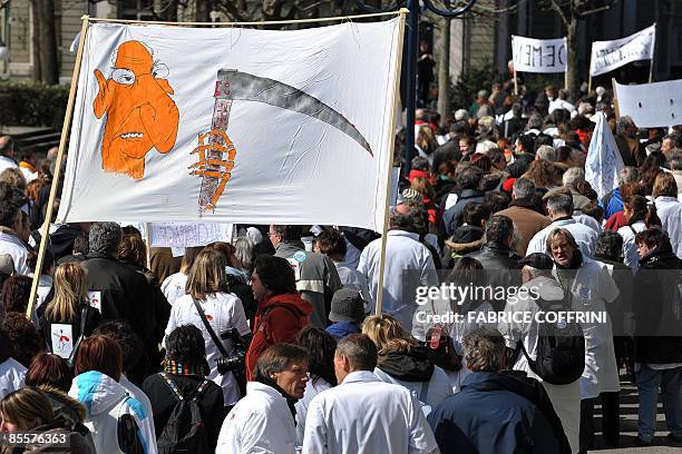 Banner wih a drawing representing Swiss health minister Pascal Couchepin is seen during a demonstration on March 24, 2009 in Lausanne. Around 1,500...