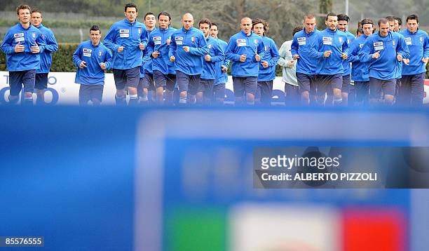 Italy's national football team players warmup during training session at the National Technical Center of Coverciano near Florence on March 24 four...