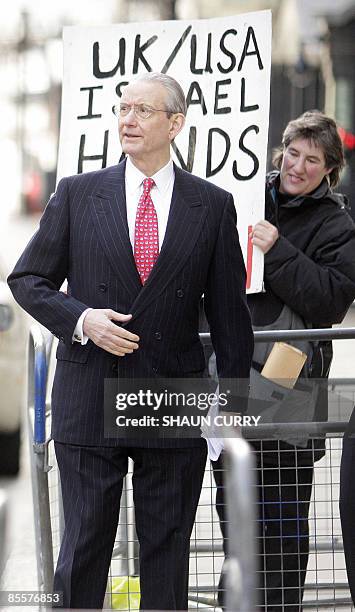 Bill Rhodes, Chairman, President and Chief Executive Officer of US bank Citibank, walks past a demonstrator as he arrives at 10 Downing Street in...