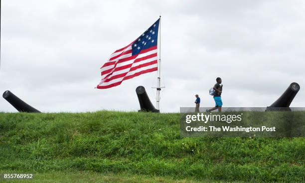 Patrons walk among the canons and an merican flag flown at Fort McHenry in Baltimore, MD on September 9, 2014. This week marks the 200th anniversity...