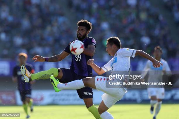 Patric of Sanfrecce Hiroshima and Akito Fukumori of Consadole Sapporo compete for the ball during the J.League J1 match between Sanfrecce Hiroshima...