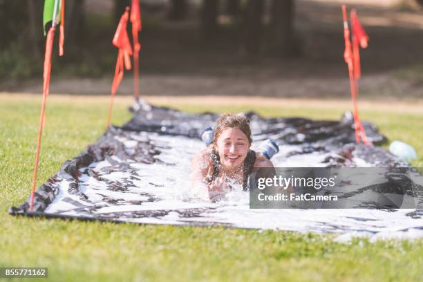 mud run fundraiser! - backyard water slide stock pictures, royalty-free photos & images