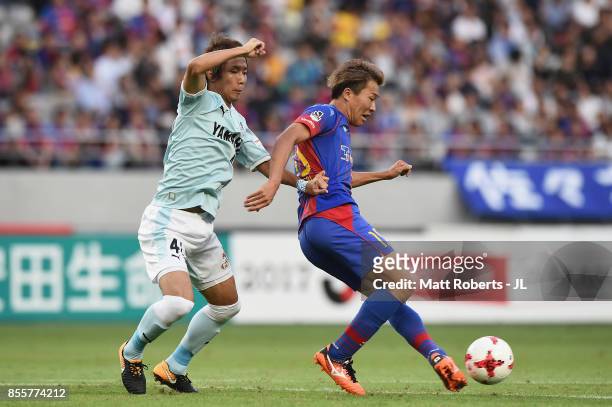 Kensuke Nagai of FC Tokyo controls the ball under pressure of Shohei Takahashi of Jubilo Iwata during the J.League J1 match between FC Tokyo and...