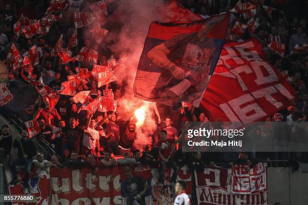 Fans of Crvena Zvezda battle using fireworks during the UEFA Europa League group H match between 1. FC Koeln and Crvena Zvezda at RheinEnergieStadion...