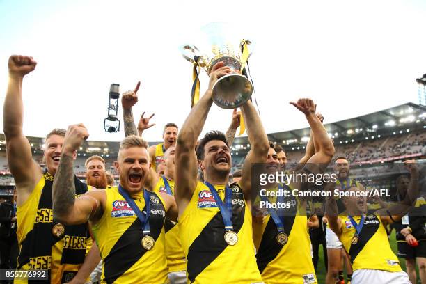 Tigers captain Trent Cotchin celebrates with team mates and holds the AFL Premiership Cup aloft after winning the 2017 AFL Grand Final match between...