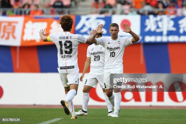 Lukas Podolski of Vissel Kobe celebrates scoring his side's second goal with his team mates Kazuma Watanabe and Kotaro Omori during the J.League J1...