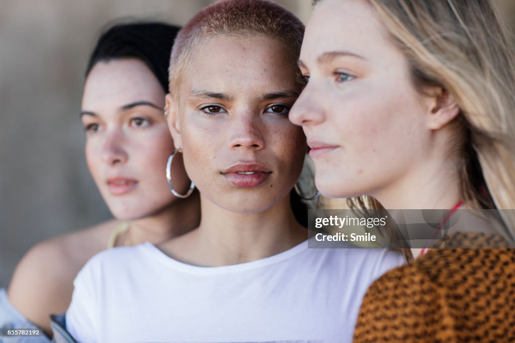 Three beautiful young women looking various directions