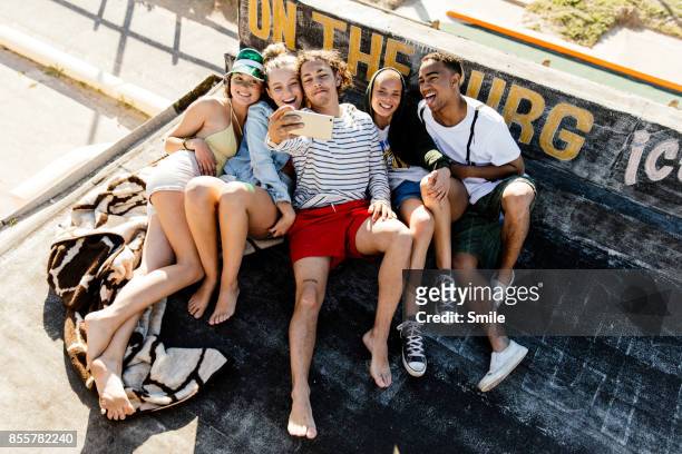 happy group of young adults taking a selfie - five people stock-fotos und bilder