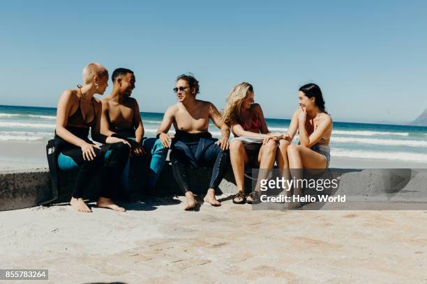 Young friends in conversation next to beach
