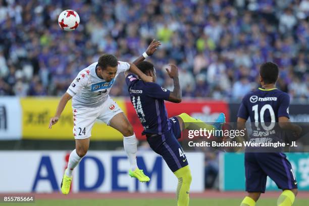 Akito Fukumori of Consadole Sapporo and Anderson Lopes of Sanfrecce Hiroshima compete for the ball during the J.League J1 match between Sanfrecce...