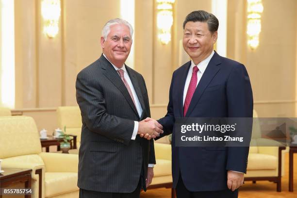 Secretary of State Rex Tillerson shakes hands with Chinese President Xi Jinping before their meeting at the Great Hall of the People on September 30,...