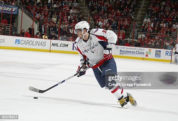 Alexander Ovechkin of the Washington Capitals carries and looks to pass the puck during a NHL game against the Carolina Hurricanes on March 21, 2009...