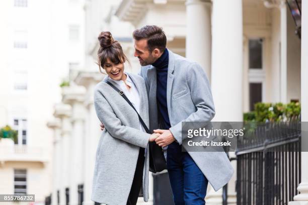 happy romantic couple flirting in the city street - upper class stock pictures, royalty-free photos & images