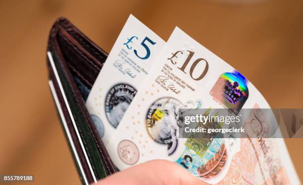 new british ten pound and five pound polymer notes in a wallet - pound stock pictures, royalty-free photos & images