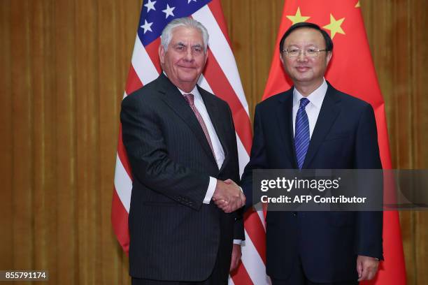 Secretary of State Rex Tillerson shakes hands with Chinese State Councilor Yang Jiechi before their meeting at the Great Hall of the People in...