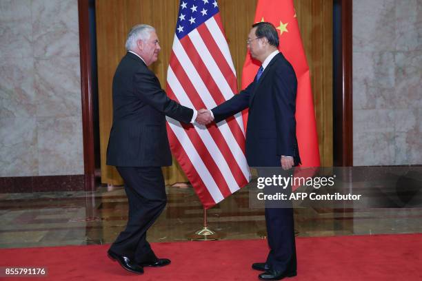 Secretary of State Rex Tillerson shakes hands with Chinese State Councilor Yang Jiechi before their meeting at the Great Hall of the People in...