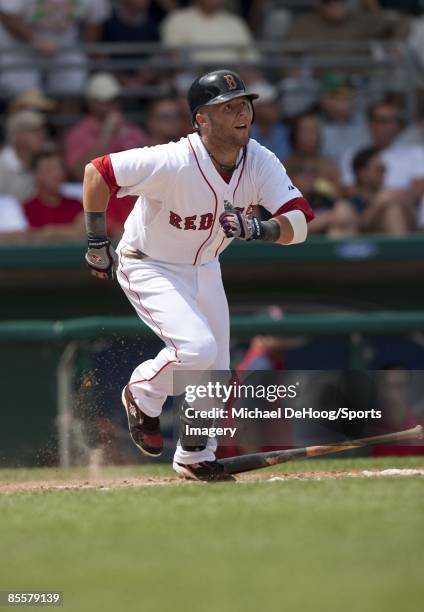 Dustin Pedroia of the Boston Red Sox runs to first base during a spring training game against the Philadelphia Phillies at City of Palms Park on...