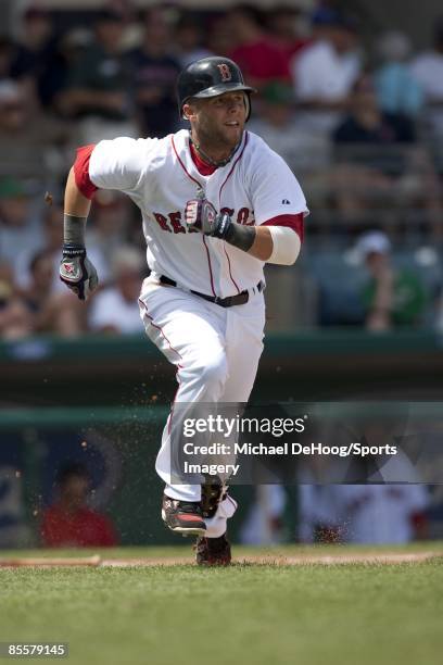 Dustin Pedroia of the Boston Red Sox runs to first base during a spring training game against the Philadelphia Phillies at City of Palms Park on...