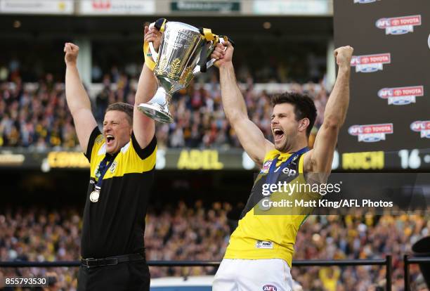Tigers head coach Damien Hardwick and Trent Cotchin captain of the Tigers celebrate and hold aloft the AFL Premiership trophy after the 2017 AFL...