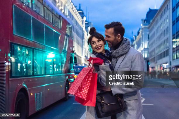 romantic couple after shopping in london at dusk, autumn season - oxford street shopping stock pictures, royalty-free photos & images