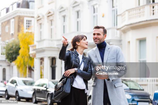 adult couple looking aroung in the city street - tourist asking stock pictures, royalty-free photos & images