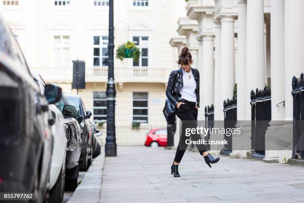 gelukkige vrouw dansen in de stad straat - grey jacket stockfoto's en -beelden